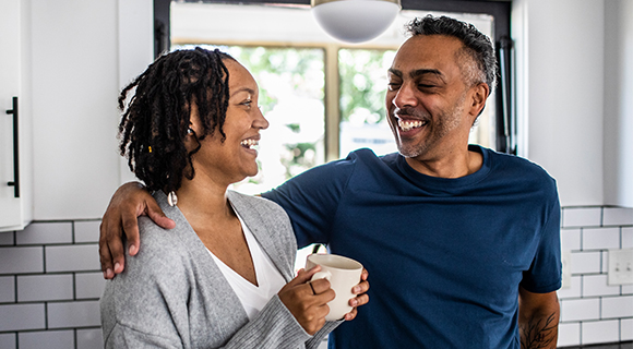 Couple smiling in kitchen